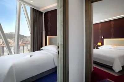 two beds in a hotel room with a window at Burgu Arjaan by Rotana Istanbul Asia in Istanbul