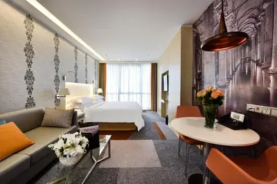 a hotel room with a bed and a couch at Tango Arjaan by Rotana Istanbul Asia in Istanbul