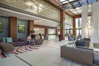 a lobby with couches and tables in a building at Tango Arjaan by Rotana Istanbul Asia in Istanbul
