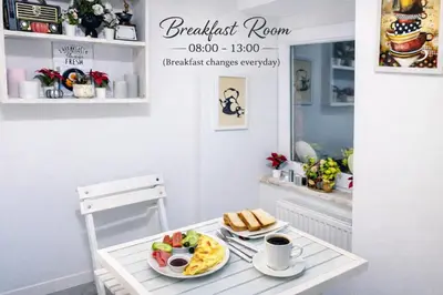 a breakfast room with a table with a plate of food at Istanberry - Scarlet Three Bedroom Apartments in Istanbul
