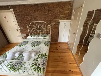 a bedroom with a bed and a brick wall at Istanberry - Joker Apartments in Istanbul