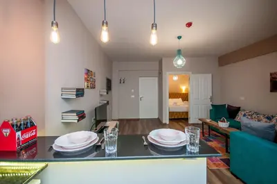a living room with a table with plates on it at Newway Apartments in Istanbul