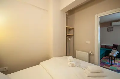 a small room with a bed with towels on it at Newway Apartments in Istanbul