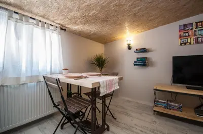 a room with a table with chairs and a television at Newway Apartments in Istanbul