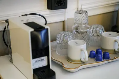 a toaster sitting on a counter with cups and glasses at Leila Mansion Hotel in Tekirdag