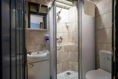 a bathroom with a shower and a toilet and a sink at TaksimAntiqueOtel in Istanbul