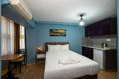 a bedroom with a large bed and a blue wall at TaksimAntiqueOtel in Istanbul