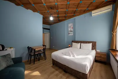 a bedroom with a bed and a chair and a table at TaksimAntiqueOtel in Istanbul