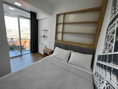 a bedroom with a large bed and a large window at Akaretler City View between Nişantaşı and Beşiktaş in Istanbul