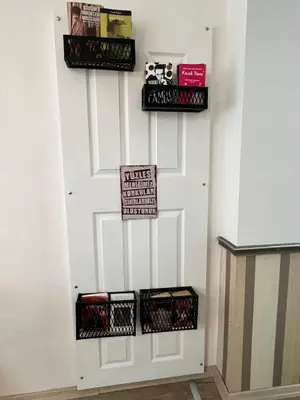 a white door with three baskets of books at Akaretler City View between Nişantaşı and Beşiktaş in Istanbul