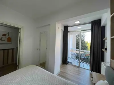 a bedroom with a bed and a view of a patio at Akaretler City View between Nişantaşı and Beşiktaş in Istanbul