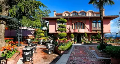 a pink house with tables and chairs in front of it at Sultanahmet Palace Hotel in Istanbul