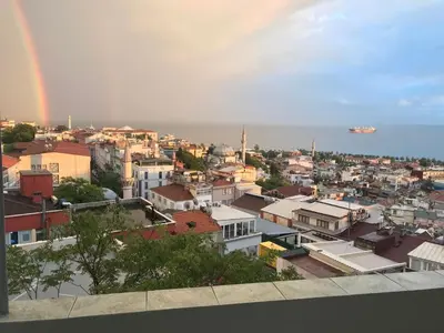 a view of a city with a rainbow in the sky at Bosphorus view, Great location and Cozy House! in Istanbul