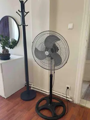 a black fan sitting on top of a wooden floor at Bosphorus view, Great location and Cozy House! in Istanbul