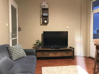 a living room with a couch and a flat screen tv at Bosphorus view, Great location and Cozy House! in Istanbul