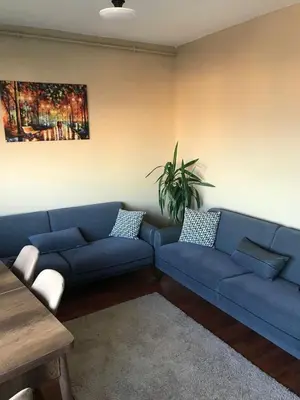 a living room with a blue couch and a table at Bosphorus view, Great location and Cozy House! in Istanbul