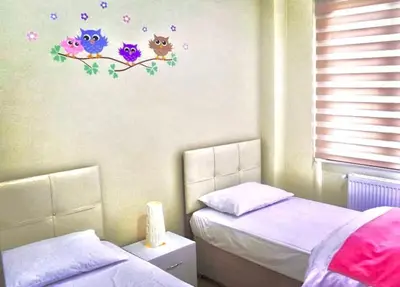 a bedroom with two twin beds and flowers on the wall at Ada Villam in Sapanca