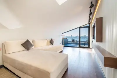 a living room with a couch and a large window at 216 Bosphorus Suite in Istanbul