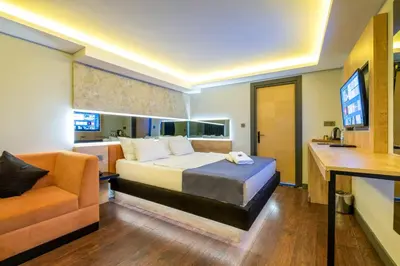 a bedroom with a bed and a couch and a television at 216 Bosphorus Suite in Istanbul