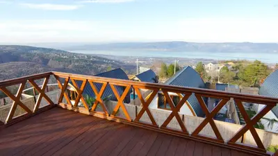 a wooden balcony with a view of the mountains at Exclusive Hill Sapanca in Sapanca