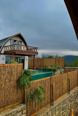 a fence with a pool in front of a house at Exclusive Hill Sapanca in Sapanca
