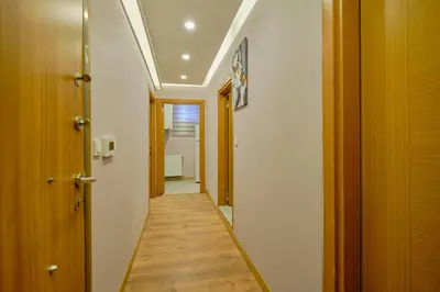a corridor of a hallway with wooden floors and a door at Daire 1 Jakuzili in Beylikduzu