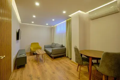 a living room with a couch and a table and chairs at Daire 1 Jakuzili in Beylikduzu