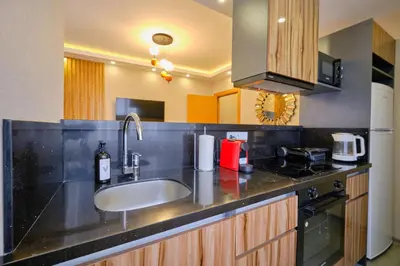 a kitchen with a sink and a stove at Daire 1 Jakuzili in Beylikduzu