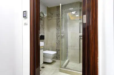 a bathroom with a toilet and a glass shower at Castle Suite in Istanbul