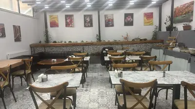 a restaurant with tables and chairs in a room at Hotel Almina İnn in Istanbul