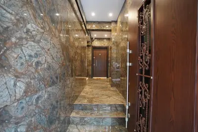 a hallway with a tile wall and a door at Hotel Almina İnn in Istanbul