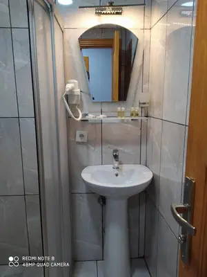 a bathroom with a sink and a mirror at Tree House Otel in Istanbul