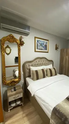 a bedroom with a bed and a mirror at Tree House Otel in Istanbul