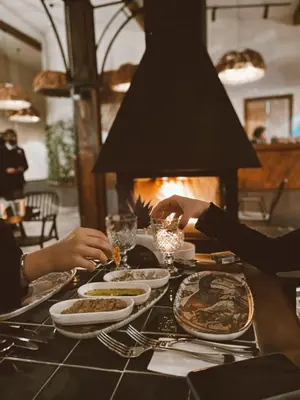 a group of people sitting at a table with food at Backyard Sapanca in Sapanca