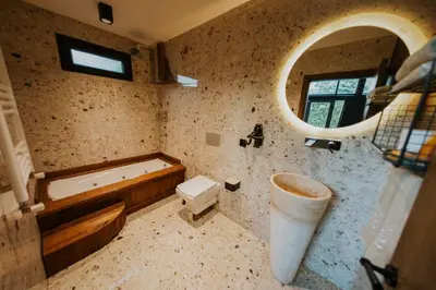 a bathroom with a tub and a toilet and a sink at Backyard Sapanca in Sapanca