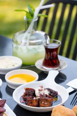a table with a plate of food and a cup of tea at Backyard Sapanca in Sapanca