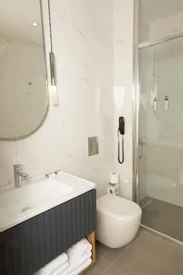 a bathroom with a sink and a toilet and a shower at Tress Hotel in Istanbul