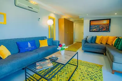 a living room with a blue couch and a table at Galata Nil Suite in Istanbul