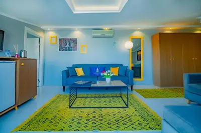 a living room with a blue couch and a table at Galata Nil Suite in Istanbul