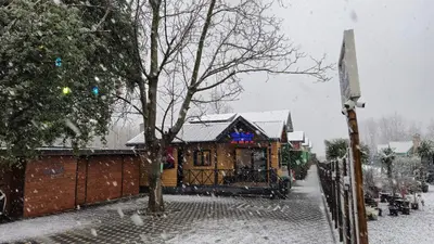 a house covered in snow in front of a fence at MSC Bungalov Sapanca in Sapanca