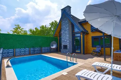 a house with a swimming pool and an umbrella at MSC Bungalov Sapanca in Sapanca