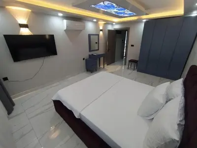 a bedroom with a bed and a flat screen tv at Daly Resort 2 in Sapanca