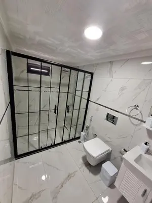 a white bathroom with a toilet and a sink at Daly Resort 2 in Sapanca