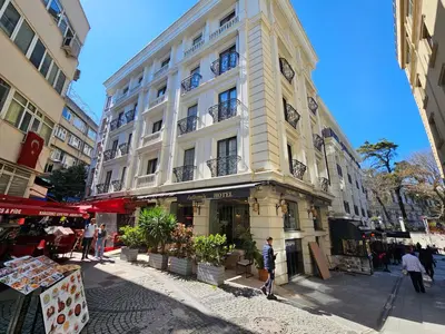 a large white building with a clock on the side of it at Anthemis Hotel in Istanbul