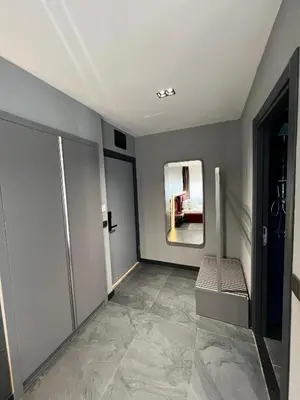 a room with a hallway with a chair and a mirror at Abone Suites in Istanbul
