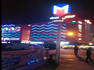 a krispy kreme sign in front of a hotel at night at Country , two bedroom and livingroom on Main Street in Çekmeköy