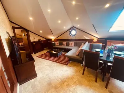 a living room with a couch and a table at Retro, two bedroom and livingroom on Main Street in Çekmeköy