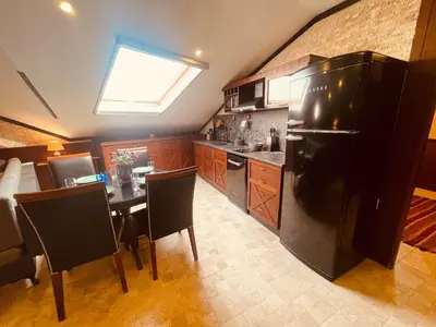 a kitchen with a black refrigerator and a table with chairs at Retro, two bedroom and livingroom on Main Street in Çekmeköy