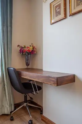 a desk with a vase of flowers and a chair at Super house 75 mt 2 bedrooms 1 living room Istanbul center in Istanbul