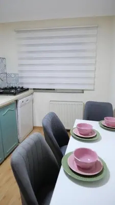 a kitchen with a table with two pink plates on it at Stylish Triplex with Turkish Bath, Terrace, Central Location in Istanbul